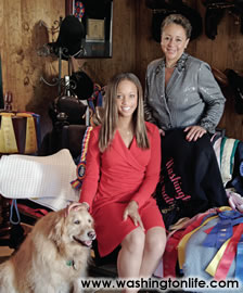Equestrian Excellence Shelia and Paige Johnson with their golden retreiver in their riding barn at Salmandor Farm in Middleburg, Va.