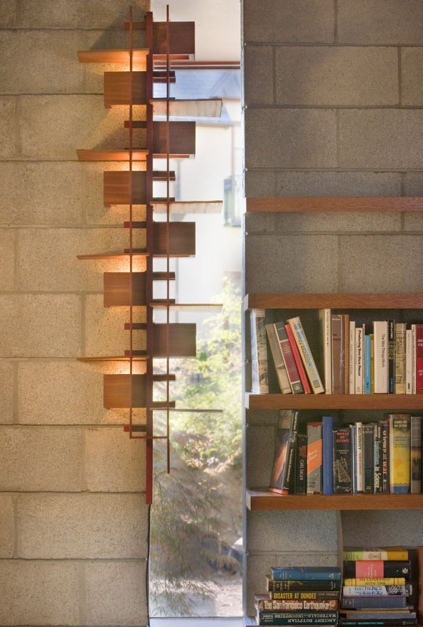 Natural light filters through slit windows, imbued with additional texture from a wooden sconce.