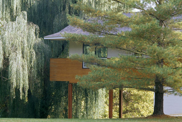 The master bedroom suite is encircled in a lush canopy of weeping willows, which shade the windows in lieu of curtains. 