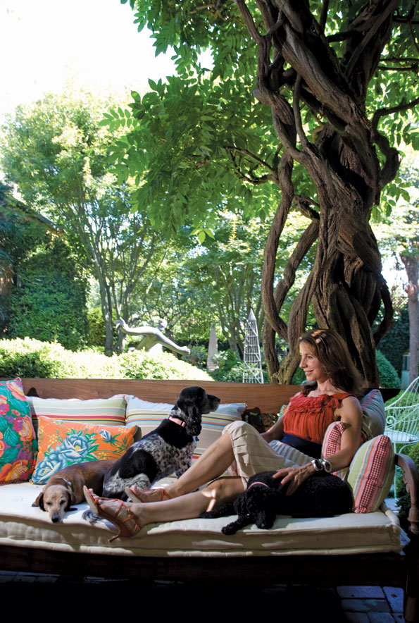 Irene Danilovich lounges on her terrace with her beloved dogs: Gabriel the dachshund, Holly the cocker spaniel and Aphrodite the French poodle.