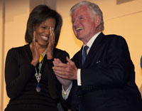 Michelle Obama leads the applause for Sen. Ted Kennedy.