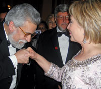 Portuguese Ambassador João de Vallera plants a deft kiss upon the hand of Hillary Rodham Clinton at the Eastern Inaugural ball at Union Station.