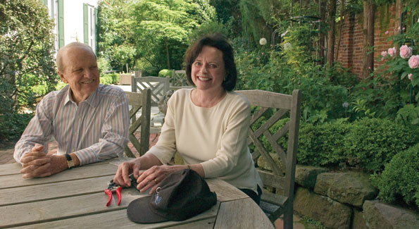 George Stevens (left) joins his wife Liz on one of several  tranquil terraces that surround their spacious Georgetown residence.