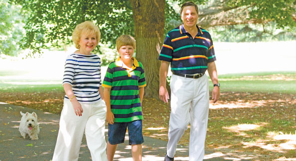 Ambassador of the Russian Federation Yuri Uskahov, his wife Svetlana, and grandson Misha, followed by dog Simon, stroll the lushly planted grounds of the Eastern Shore dacha. 