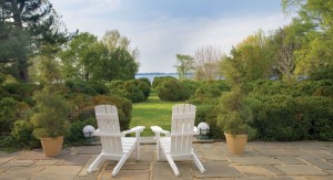 From the rear flagstone patio, a view of the Chester River beckons through clustered boxwoods. 