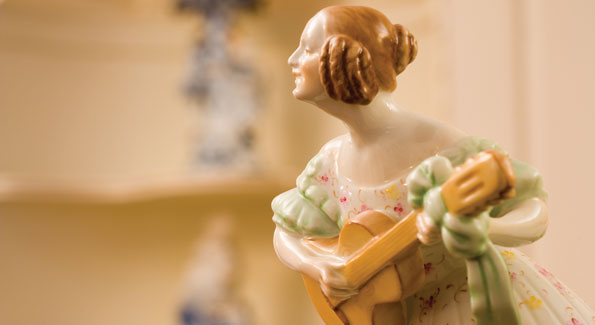 A dainty figurine represents the home's impressive collection of German and Hungarian porcelains. 