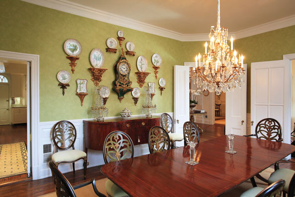 In the dining room, Danish botanical plates are arranged over a Hepplewhite mahogany sideboard, circa 1800.