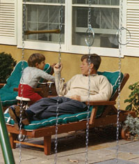 President John F. Kennedy relaxes with  John Jr. on the patio of Wexford, his Middleburg retreat on November 10, 1963. (Photo by Cecil Soughton, The White House)  