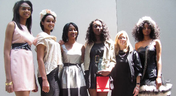 Adegbemisola Ademisoye poses with models decked out in her designs.