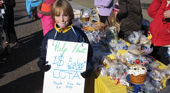 Ben, a student at Lyles-Crouch Traditional Academy, helped raise over $1,500 for Haiti in Old Town Alexandria’s Farmers’ Market. (Photo by Jane Hess Collins)