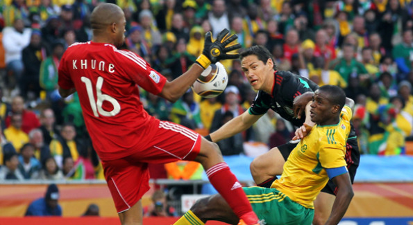 South African Itumeleng Khune (pictured right) blocks shot from Guillermo Franco, (pictured center), of Mexico. Courtesy of Getty images.
