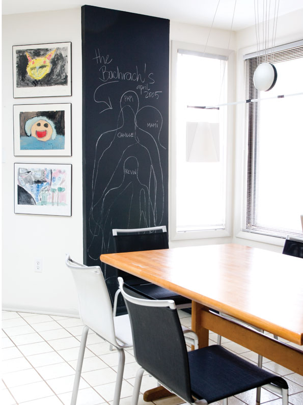 Framing their children’s artwork and including  a chalkboard height chart adds more than a  touch of whimsy to the family’s dining area. (Photo by John Heale) 