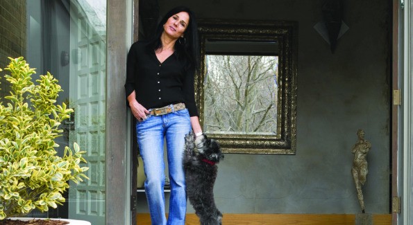 Architect Deborah Kalkstein with dog Hilton stand at the entryway of her modern Potomac, Md. home.  (photo by John Heale)