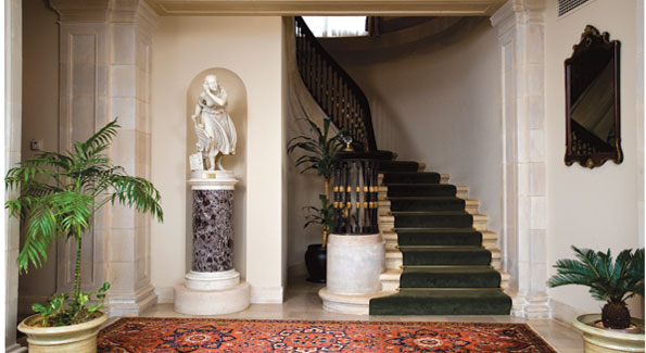 Velvet handrails encase the graceful circular staircase. "Nydia, The Blind Girl of Pompei" by Randolph Rogers greets guests in a special alcove. Photos by Joseph Allen.