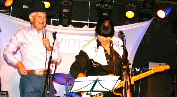 Bob Schieffer takes the stage with Honky Tonk Confidential band member Diana Quinn at the Mr. Holland’s Opus Foundation benefit. (Photo by Janet Donovan)