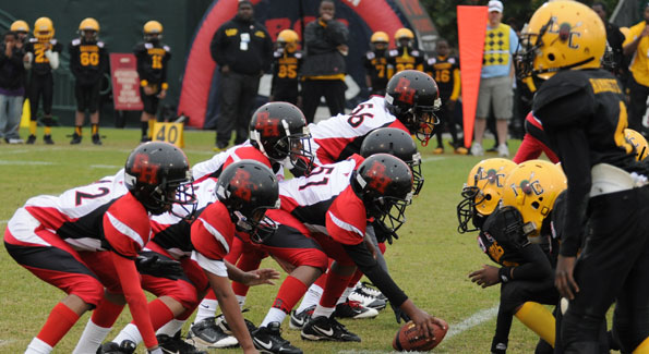 The Beacon Hill Falcons (in red, white and black) crushed the Liberty City Warriors (in yellow and black) 19-0 to win the Pop Warner Junior Pee Wee Superbowl championship. (Photo courtesy of Beacon House)
