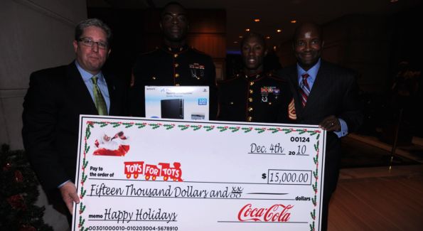 Coca Cola executives presents the check to Toys for Tots. Image courtesy of Brett Bagley.