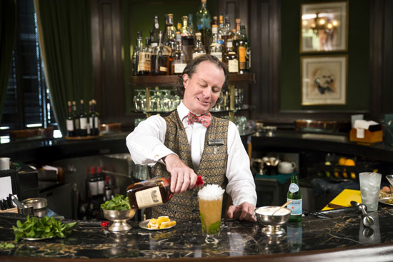 Hewes making the Round Robin's signature mint julep.