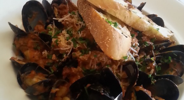 Order the Black Mussels with Hot Italian Sausage at Trevi 5, and sop up the spicy sauce with grilled bread. Photo courtesy of Kelly Magyarics.