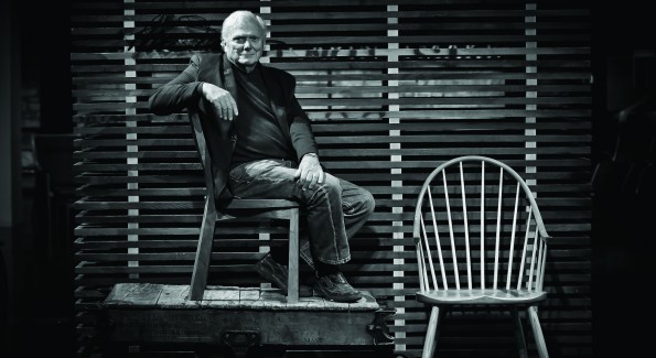 Tom Moser, founder of Thos. Moser Handmade American Furniture, poses next to his signature continuous armchair in his new Georgetown showroom. Photo by Tony Powell.