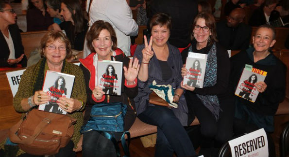 Guests hold Gloria Steinem's book "My Life on the Road" (Photo by Bruce Guthrie)