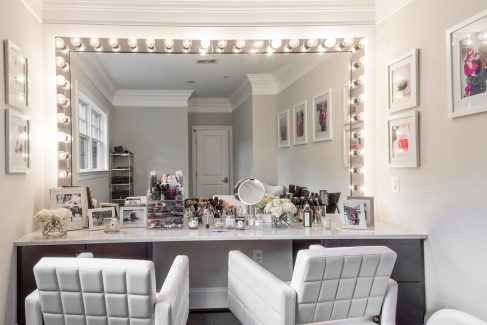 The “glam room” on the second floor features white swivel chairs and a wall of mirrors.