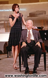 Actress MEG GILLENTINE sings to GILBERT MEAD