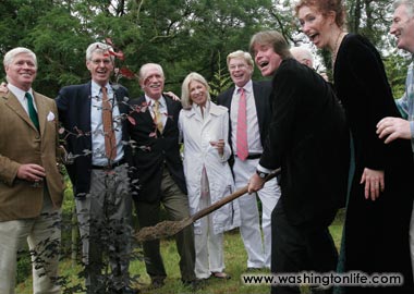 Carlotta Hester and Chris Murray plant a tree on cousin Gerry Murray’s farm