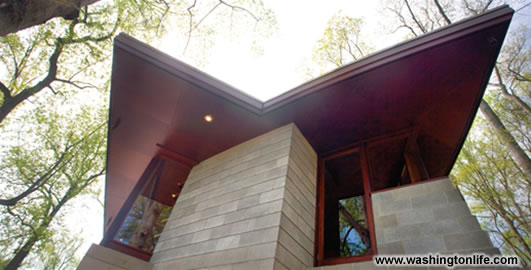 The restrained exterior features a flat copper roof